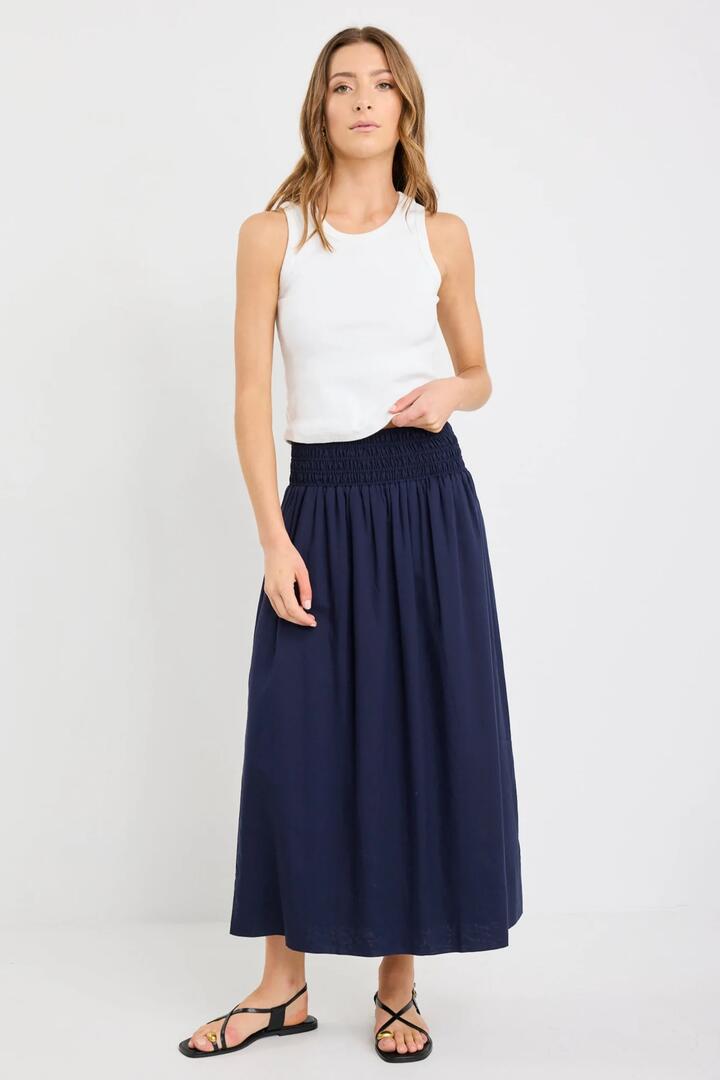 Image of a model wearing Skirts. Product name - Wanderlust Navy Linen Blend Shirred Waist Maxi Skirt in Navy colour by brand - Stories be Told