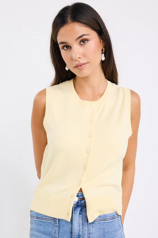 Image of a model wearing Outerwear. Product name - Alleyway Butter Lightweight Soft Knit Crewneck Vest Top in Butter colour by brand - Among the Brave