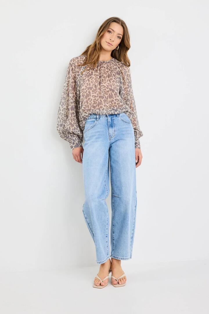 Image of a model wearing Tops. Product name - Cosmopolitan Leopard Print Crew Neck Floaty LS Top in Leopard Print colour by brand - Stories be Told