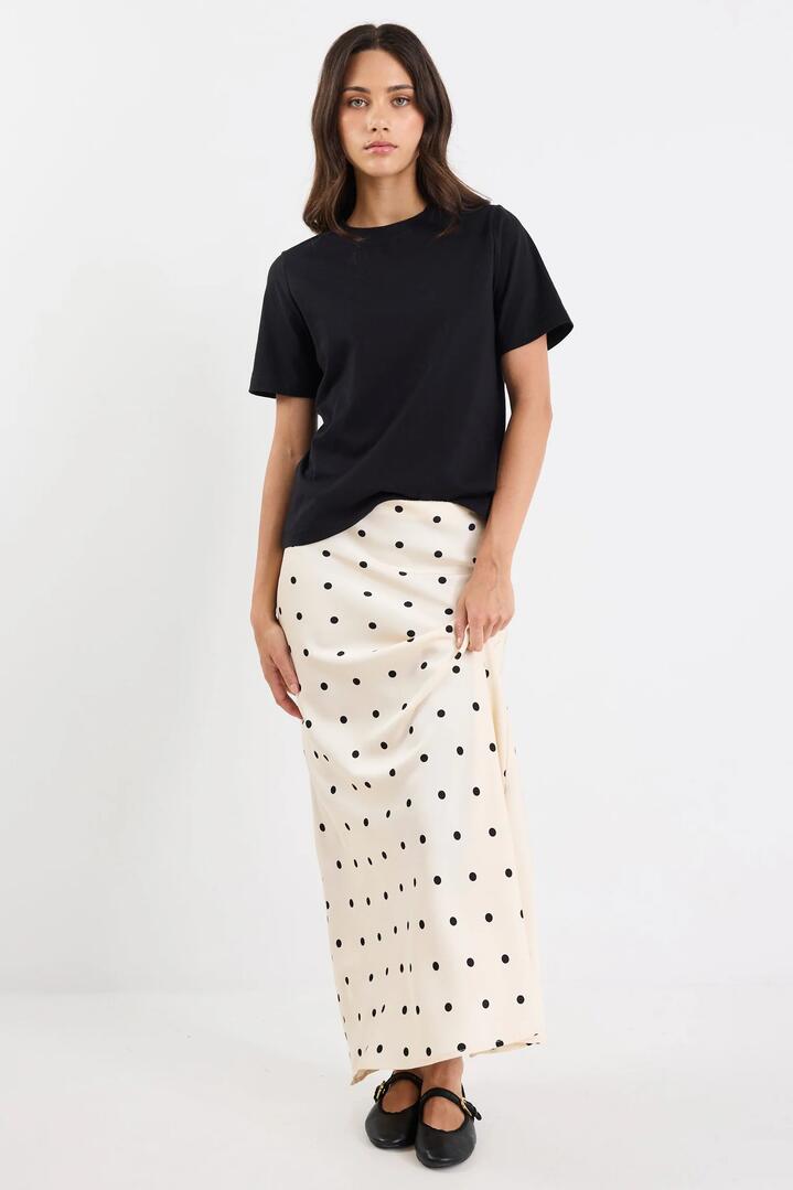 Image of a model wearing Skirts. Product name - Prodigy Cream Black Polka Dot Satin Bias Cut Midi Skirt in Cream Black Polka Dot colour by brand - Stories be Told