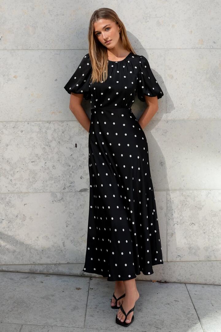 Image of Dresses. Product name - Stage Black Polka Dot Puff Sleeve Floaty Maxi Dress in Black Polka Dot colour by brand - Stories be Told