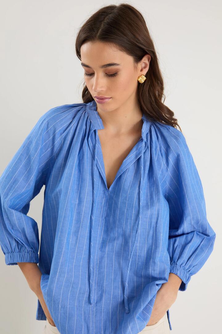 Image of a model wearing Tops. Product name - Compliment French Blue Stripe Blouson Mid Sleeve Top in French Blue Stripe colour by brand - By Rosa.
