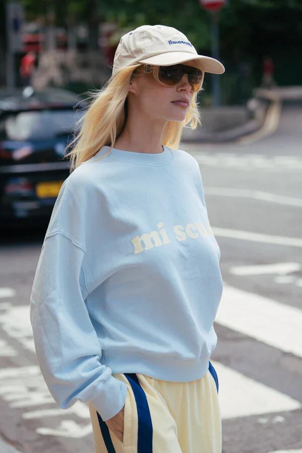 Image of a model wearing Outerwear. Product name - Mi Scusi Washed Glacier Sweatshirt in Blue colour by brand - Araminta James