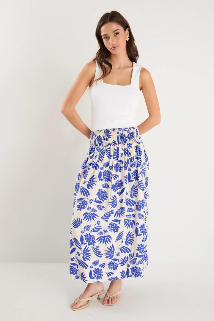 Image of a model wearing Skirts. Product name - Sangria Blue Lotus Viscose Blend Shirred Waist Maxi Skirt in Blue Lotus colour by brand - By Rosa.