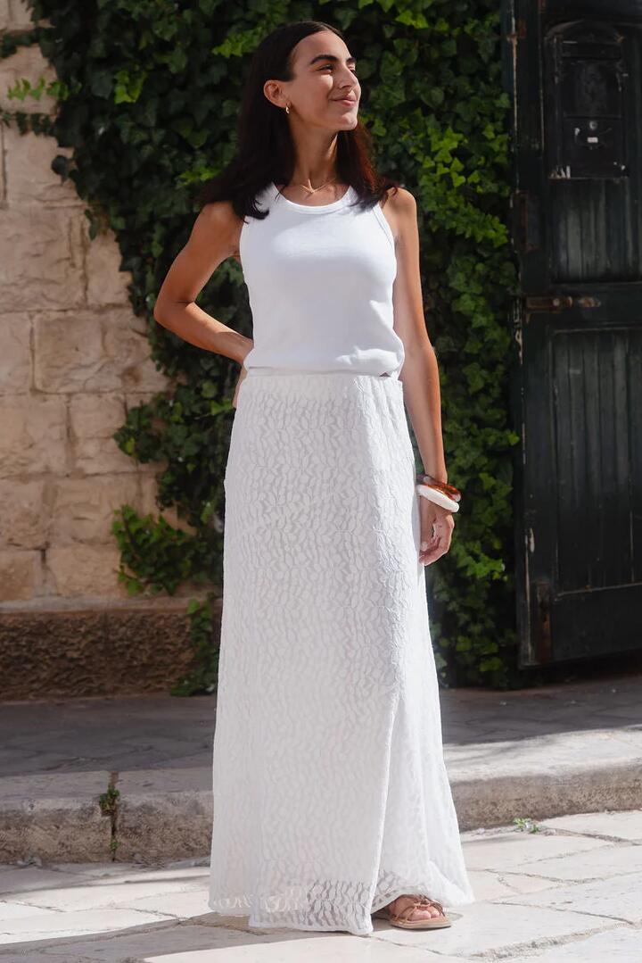 Image of a model wearing Skirts. Product name - Zeus Ivory Lace Bias Maxi Skirt in Ivory colour by brand - Stories be Told