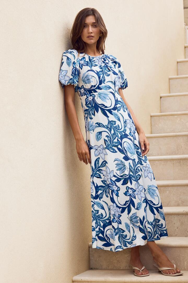 Image of Dresses. Product name - Stage Blue Floral Puff Sleeve Floaty Maxi Dress in Blue Floral colour by brand - Stories be Told