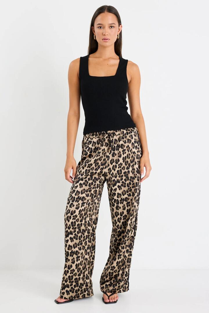 Image of a model wearing Pants. Product name - Townie Animal Satin Tape Side Elastic Waist Pants in Animal Satin colour by brand - Stories be Told