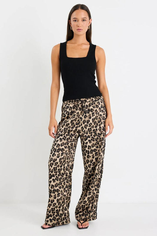Image of a model wearing Pants. Product name - Townie Animal Satin Tape Side Elastic Waist Pants in Animal Satin colour by brand - Stories be Told