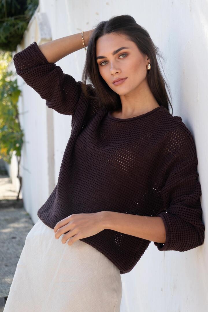 Image of a model wearing Outerwear. Product name - Dawn Chocolate Crochet Knit Jumper in Chocolate colour by brand - RE:UNION Label