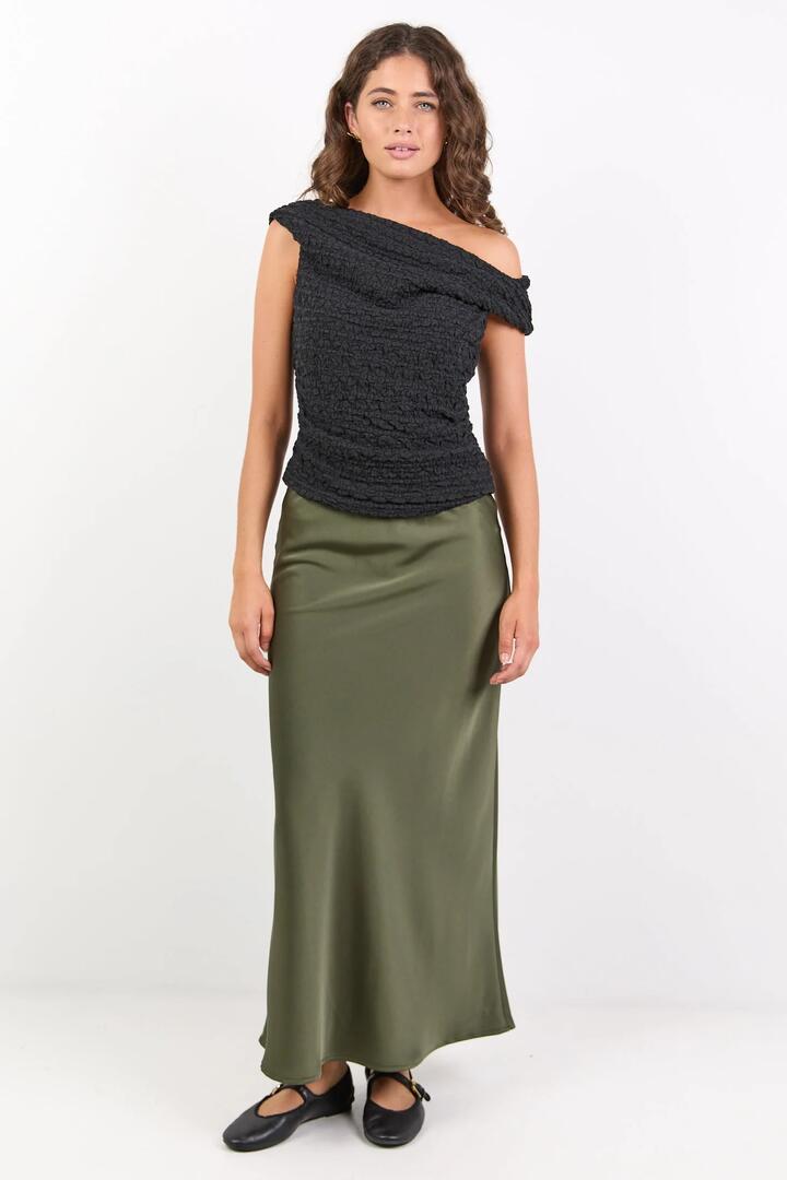 Image of a model wearing Skirts. Product name - Rosette Khaki Satin Bias Midi Skirt in Khaki colour by brand - Ivy + Jack