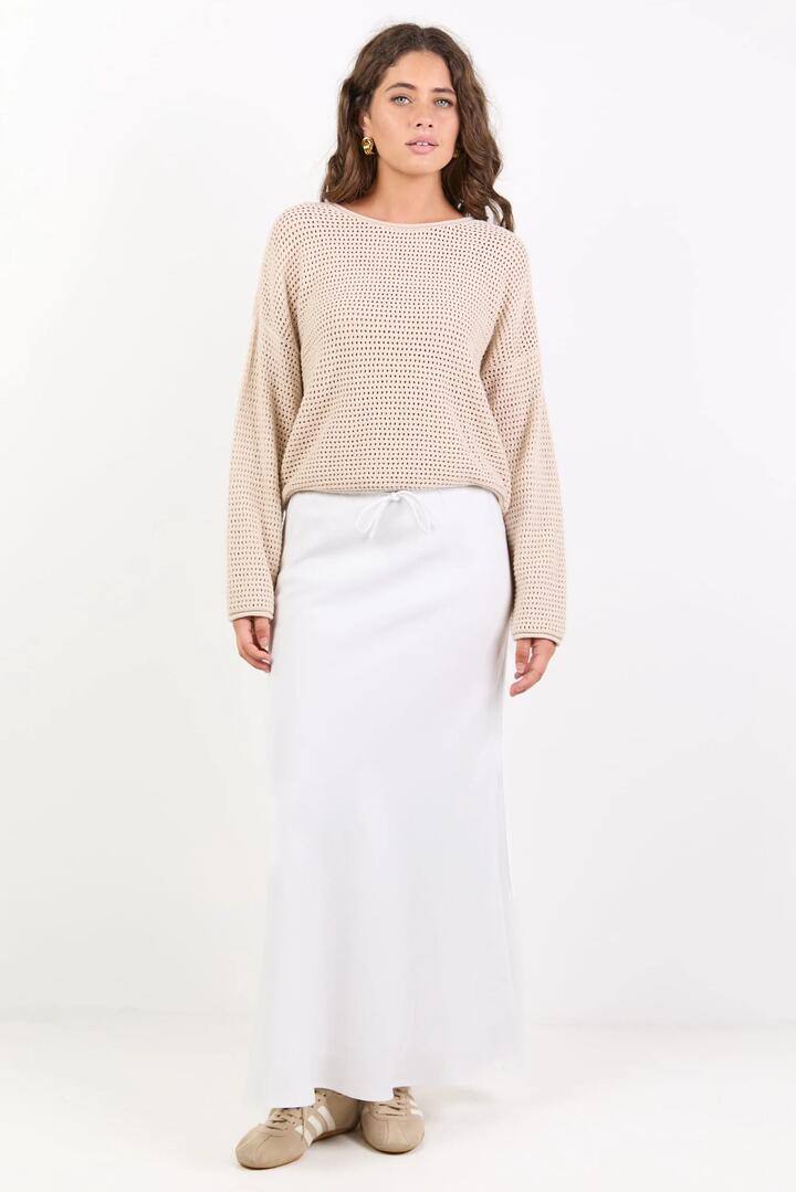 Image of a model wearing Skirts. Product name - Summit White Linen Blend Tie Waist Bias Maxi Skirt in White colour by brand - Among the Brave