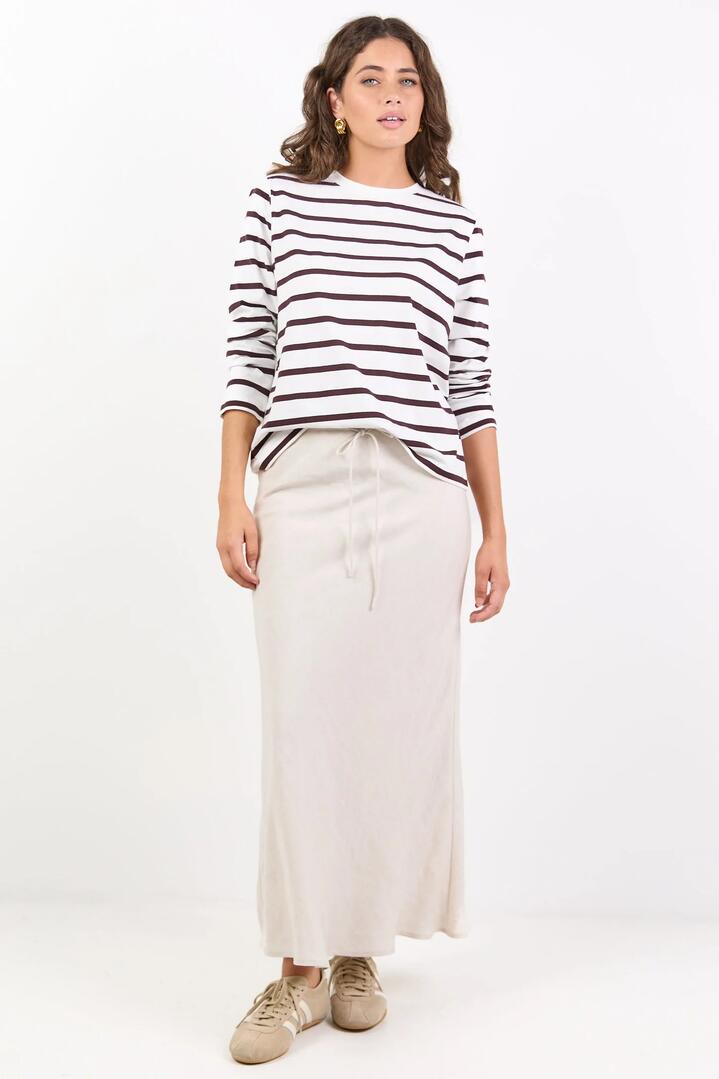 Image of a model wearing Skirts. Product name - Summit Natural Linen Blend Tie Waist Bias Maxi Skirt in Natural colour by brand - Among the Brave