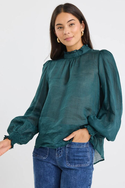 Image of a model wearing Tops. Product name - Poet Forest Long Sleeve High Neck Top in Forest colour by brand - By Rosa.