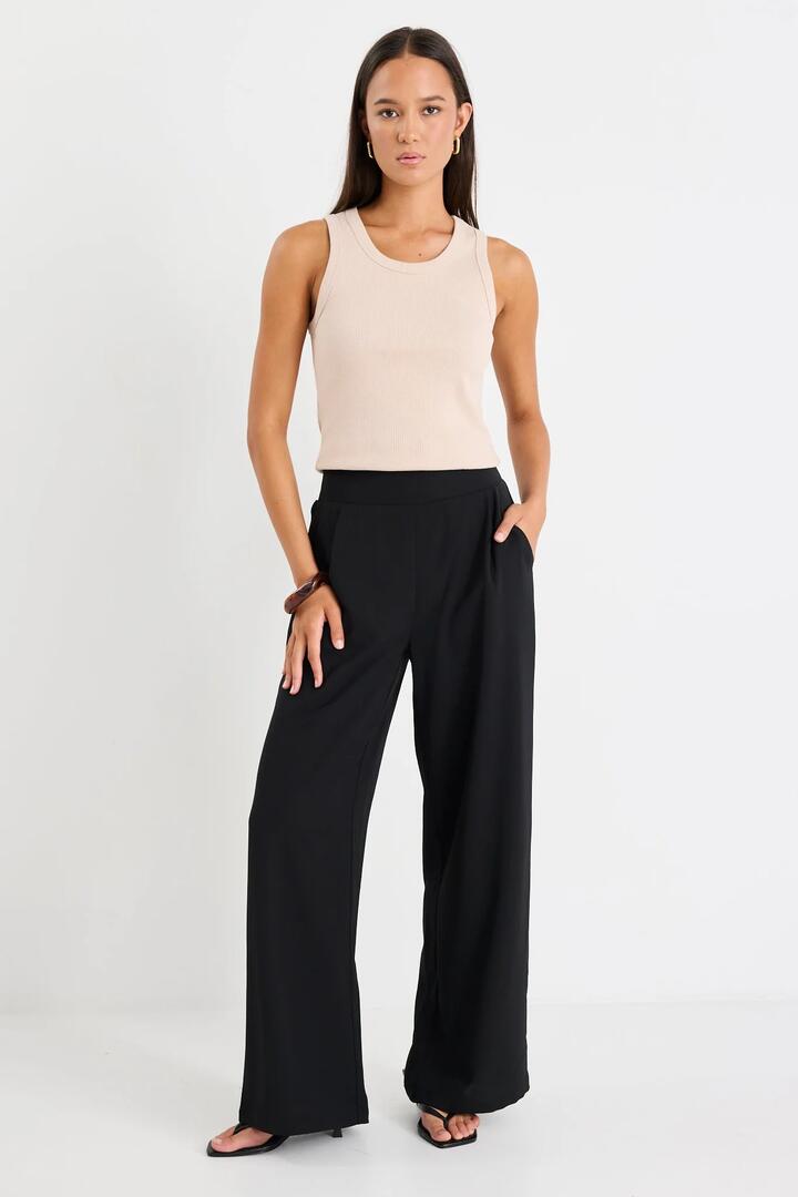 Image of a model wearing Pants. Product name - Guardian Black Linen Viscose Elastic Back Pants in Black colour by brand - Among the Brave