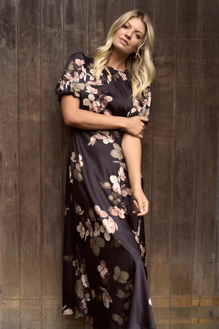 Image of Dresses. Product name - Stage Black Floral Satin Puff Sleeve Floaty Maxi Dress in Black Floral colour by brand - Stories be Told
