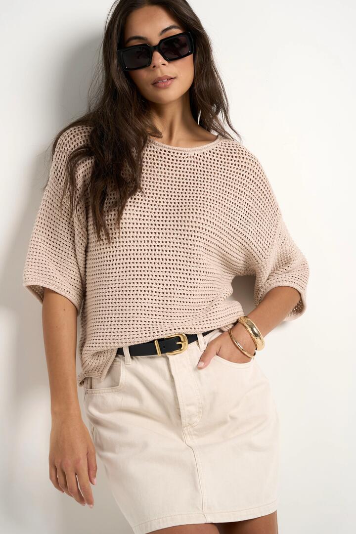 Image of a model wearing Outerwear. Product name - Sunrise String SS Crochet Knit Top in String colour by brand - RE:UNION Label