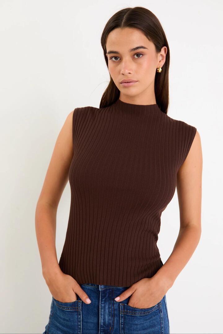 Image of a model wearing Outerwear. Product name - Heroic Chocolate Sleeveless Funnel Neck Rib Knit Top in Chocolate colour by brand - Among the Brave