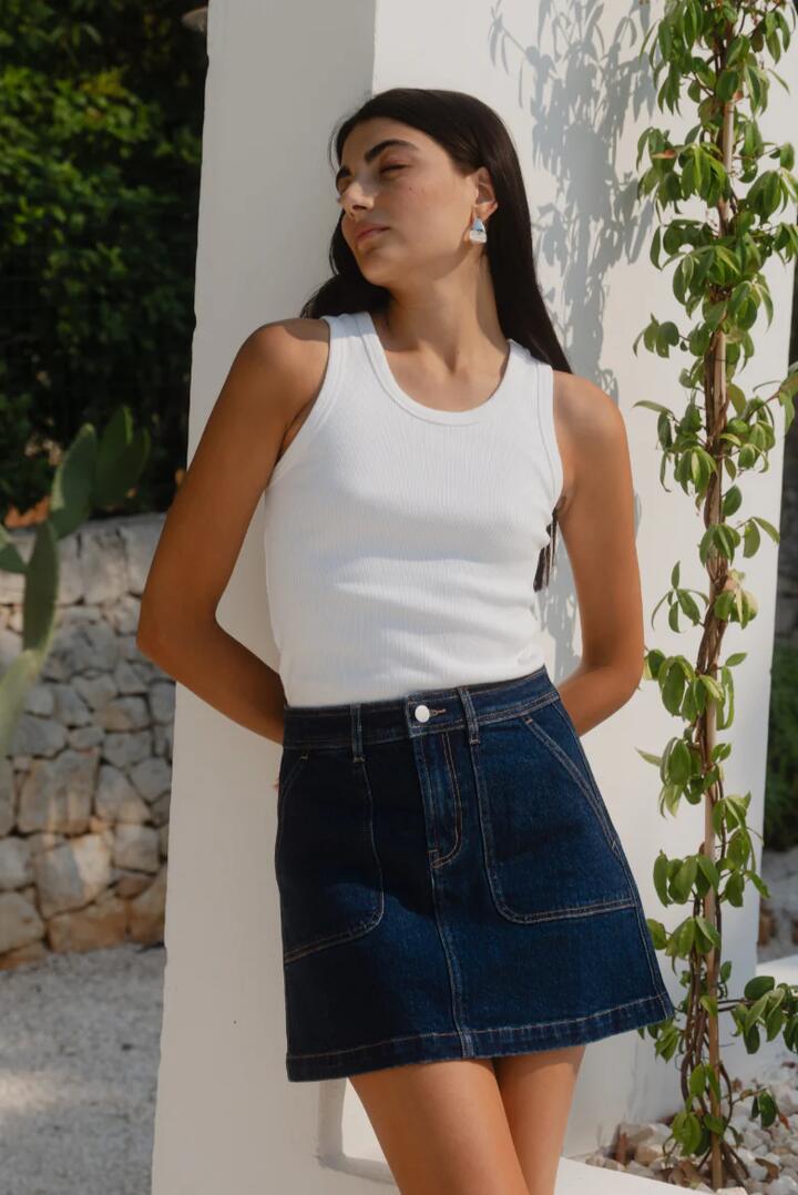 Image of a model wearing Skirts. Product name - Orchard Indigo Front Denim Mini Skirt in Indigo colour by brand - Ivy + Jack