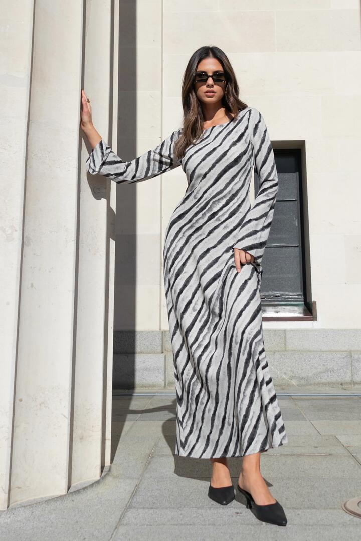 Image of Dresses. Product name - Luminous Charcoal Irregular Stripe Fluted Sleeve Bias Maxi Dress in Charcoal Irregular Stripe colour by brand - Stories be Told