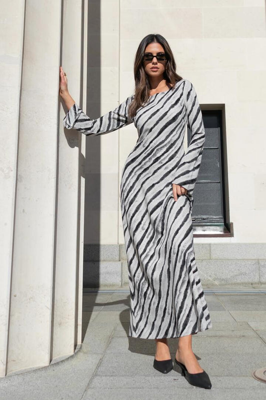 Image of Dresses. Product name - Luminous Charcoal Irregular Stripe Fluted Sleeve Bias Maxi Dress in Charcoal Irregular Stripe colour by brand - Stories be Told