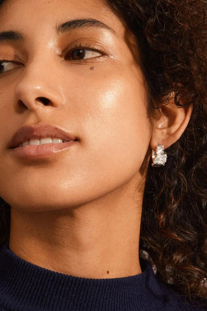 Image of Jewelry. Product name - Willpower Wavy EOL Recycled Silver Plated Huggie Hoop Earrings in Silver colour by brand - Pilgrim