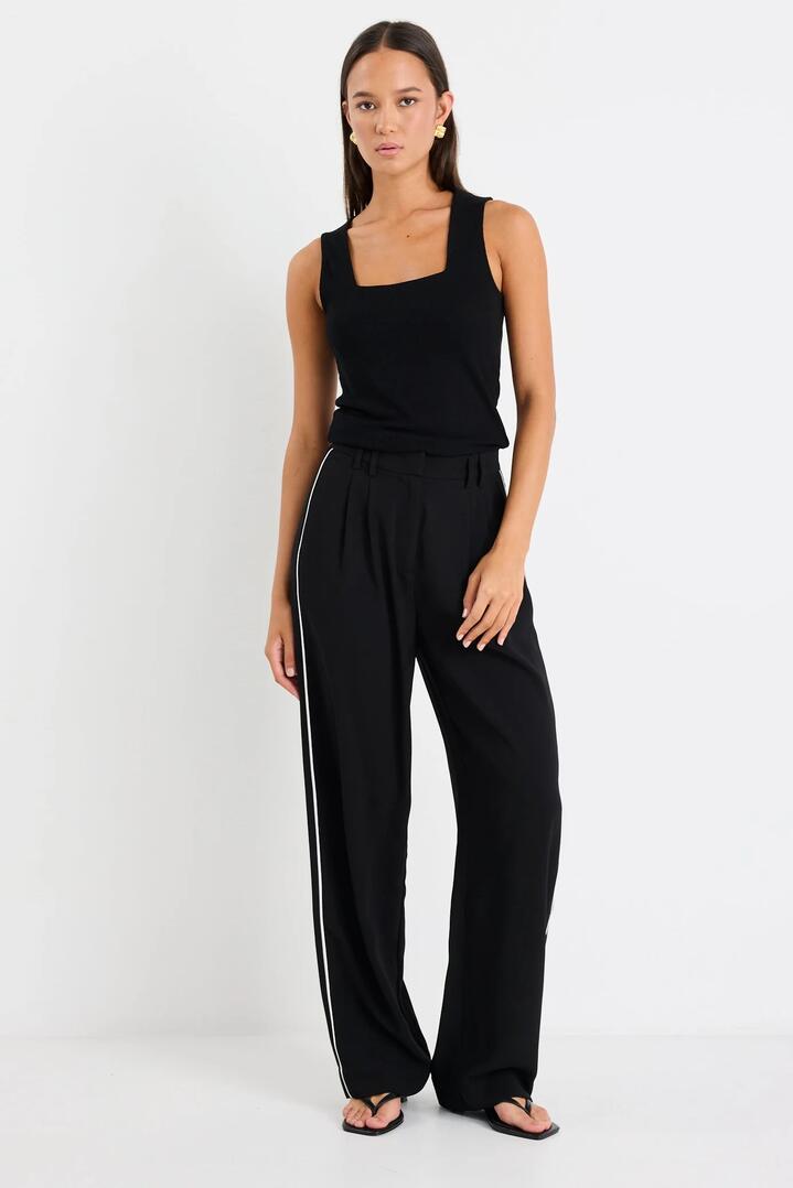 Image of a model wearing Pants. Product name - Collective Black Piped Trim Pants in Black colour by brand - Among the Brave