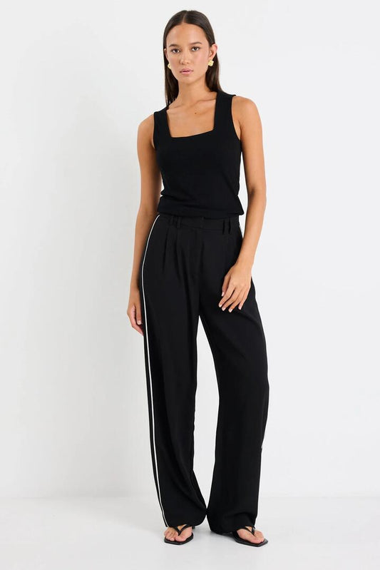 Image of a model wearing Pants. Product name - Collective Black Piped Trim Pants in Black colour by brand - Among the Brave