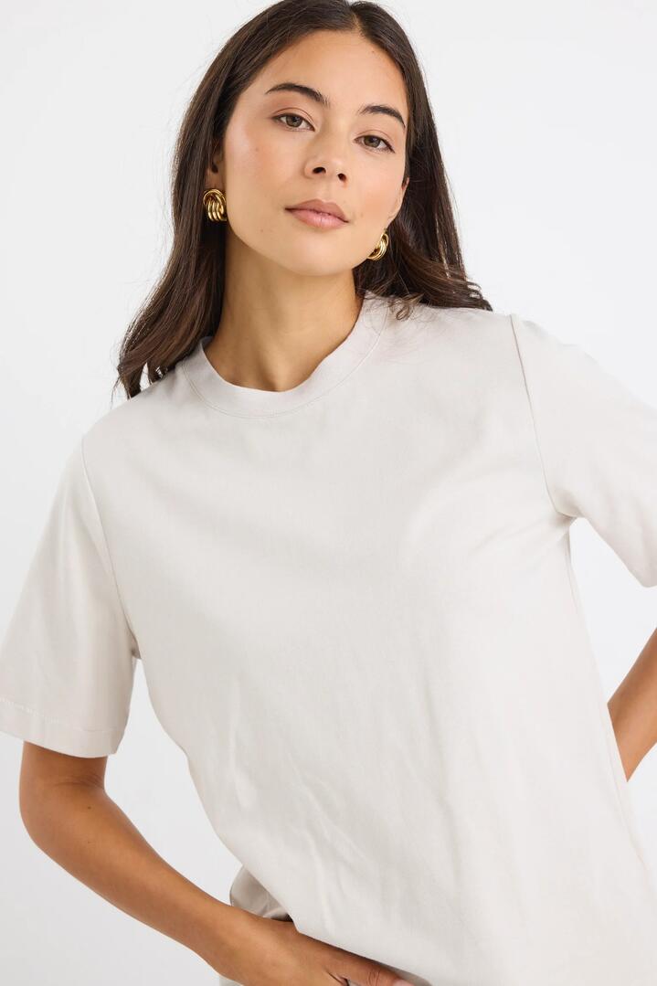 Image of a model wearing Tops. Product name - Street Stone Crew Neck Short Sleeved Boxy SS Tee in Stone colour by brand - Stories be Told