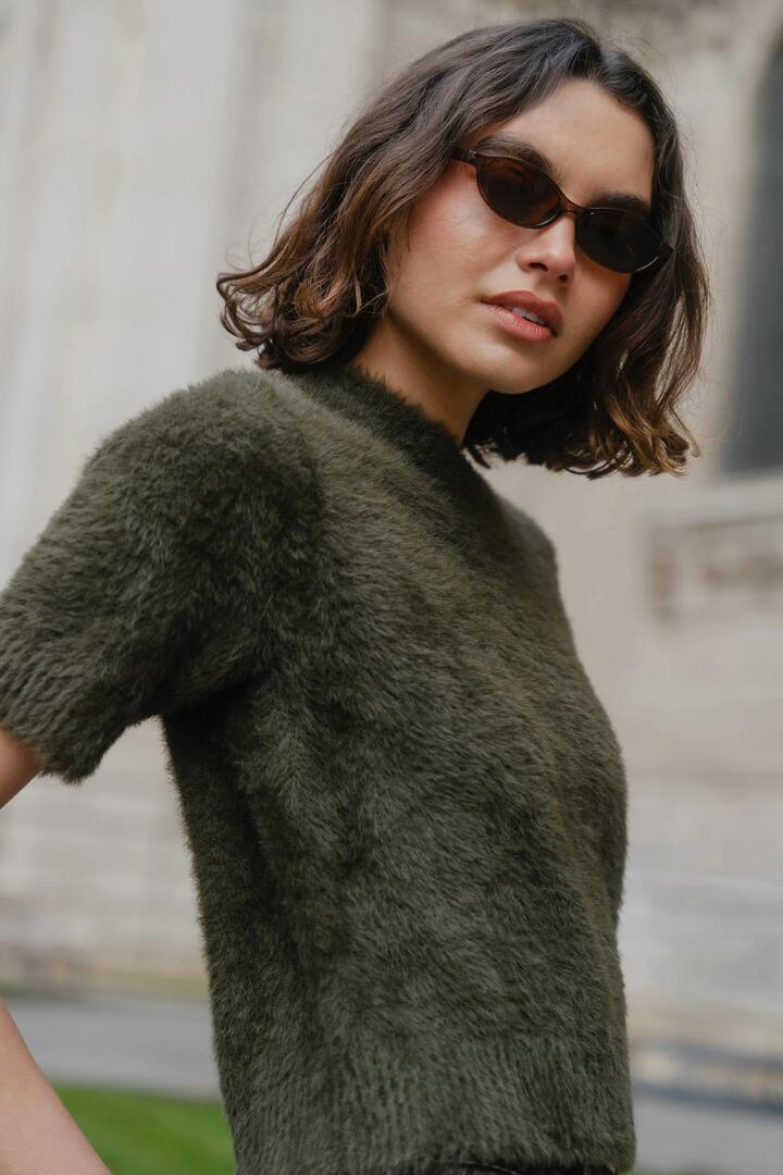 Image of a model wearing Outerwear. Product name - Issue Khaki Fluffy Soft Knit Tee in Khaki colour by brand - Ivy + Jack