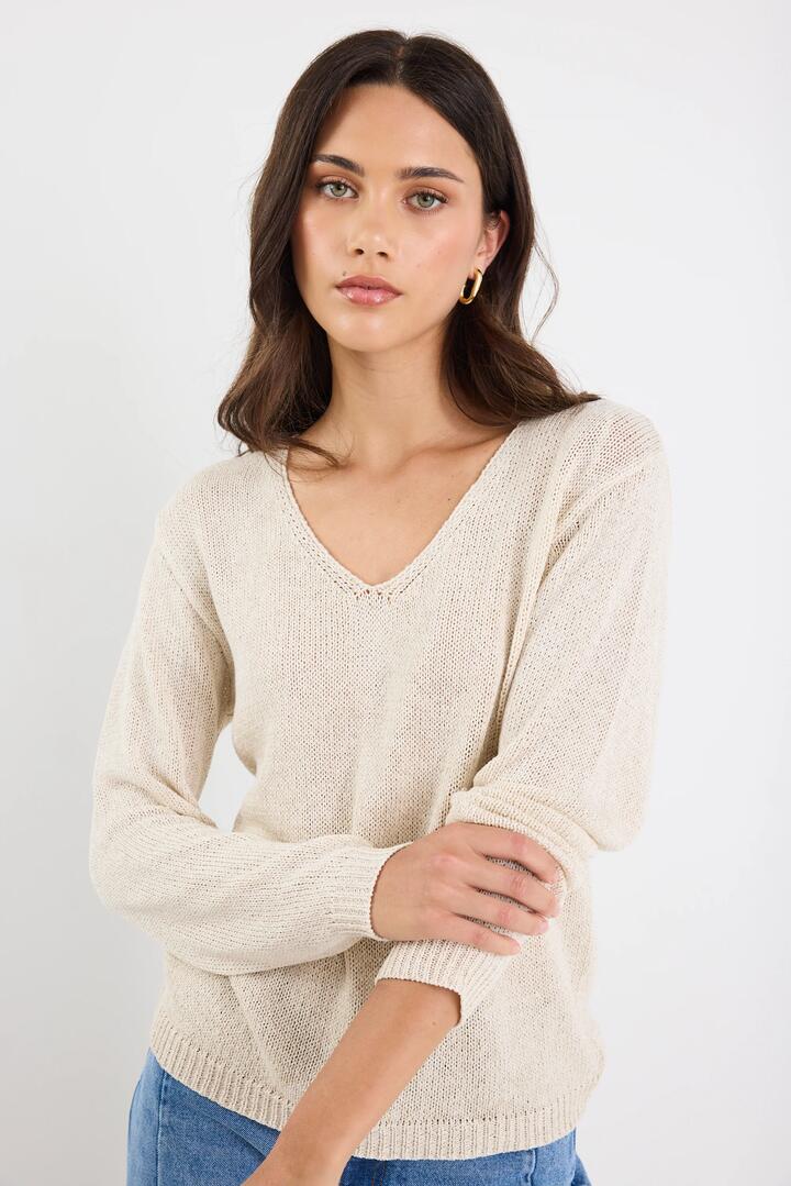 Image of a model wearing Outerwear. Product name - Afternoon Natural Relaxed V Neck Knit Jumper in Natural colour by brand - Stories be Told