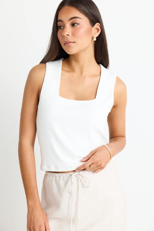 Image of a model wearing Tops. Product name - Positive Cream Rib Square Neck Tank in Cream colour by brand - Among the Brave