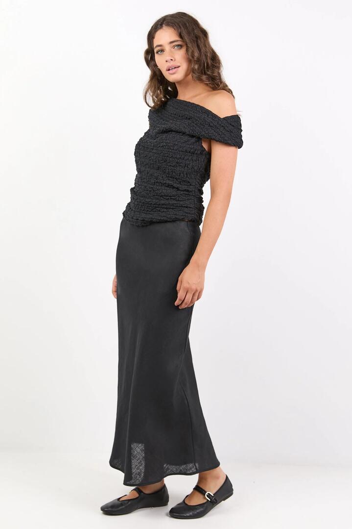 Image of a model wearing Skirts. Product name - Bliss Black Linen Bias Midi Skirt in Black colour by brand - RE:UNION Label