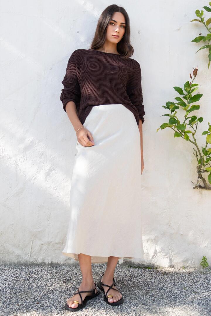 Image of a model wearing Skirts. Product name - Bliss Natural Linen Bias Midi Skirt in Natural colour by brand - RE:UNION Label