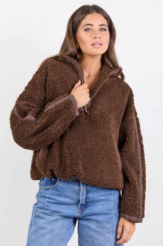 Image of a model wearing Outerwear. Product name - Untold Chocolate Contrast Detail Quarter Zip Sherpa Sweatshirt in Chocolate colour by brand - Stories be Told