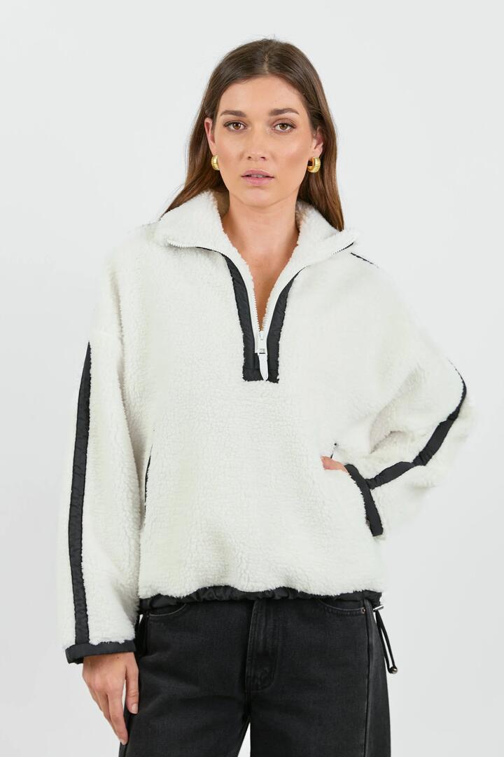 Image of a model wearing Outerwear. Product name - Untold Cream Contrast Detail Quarter Zip Sherpa Sweatshirt in Cream colour by brand - Stories be Told