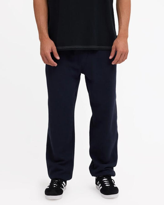 Image of a model wearing Pants. Product name - Quiksilver Mens Graphic Track Pants Dark Navy in Dark Navy colour by brand - Quiksilver