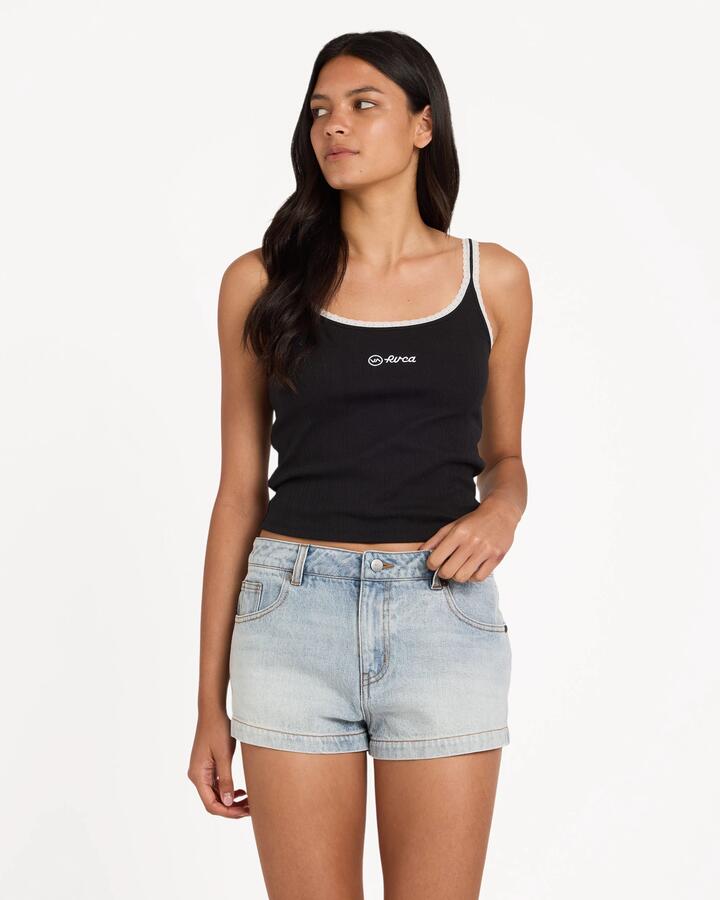 Image of a model wearing Shorts. Product name - Rvca Womens Lisha Denim Shorts Bleached Indigo in Bleached Indigo colour by brand - Rvca