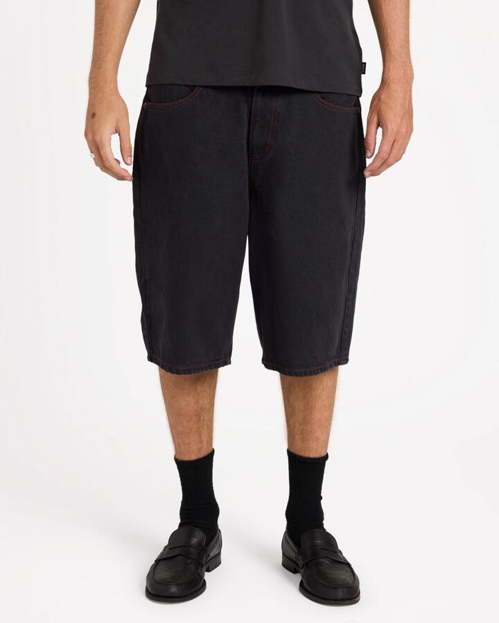 Image of a model wearing Shorts. Product name - Rvca Mens Dayshift Baggy 23.5" Denim Shorts Black in Black colour by brand - Rvca