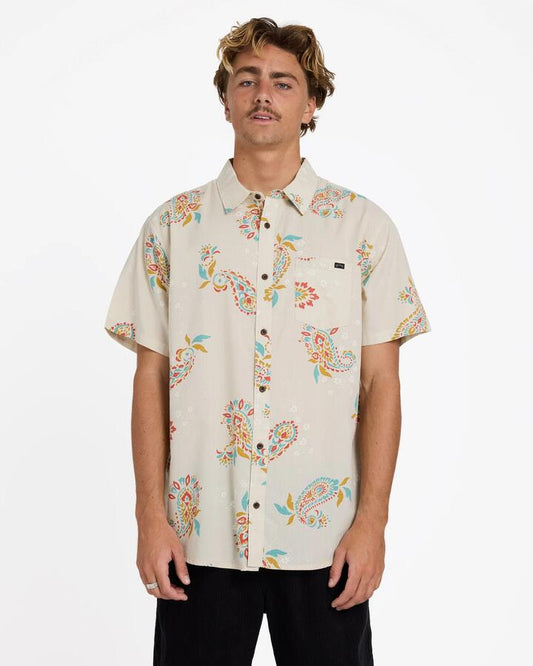 Image of a model wearing Tops. Product name - Billabong Mens Sundays Short Sleeve Shirt Oatmeal in Oatmeal colour by brand - Billabong