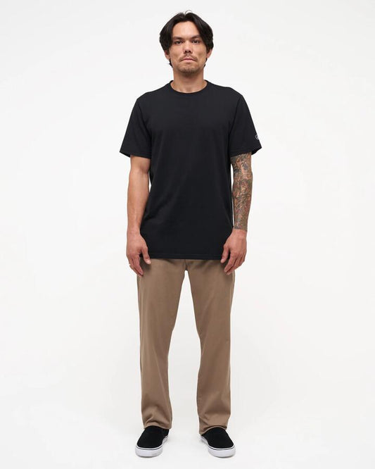 Image of a model wearing Pants. Product name - Volcom Mens Frickin Modern Stretch Chino Pants Khaki in Khaki colour by brand - Volcom