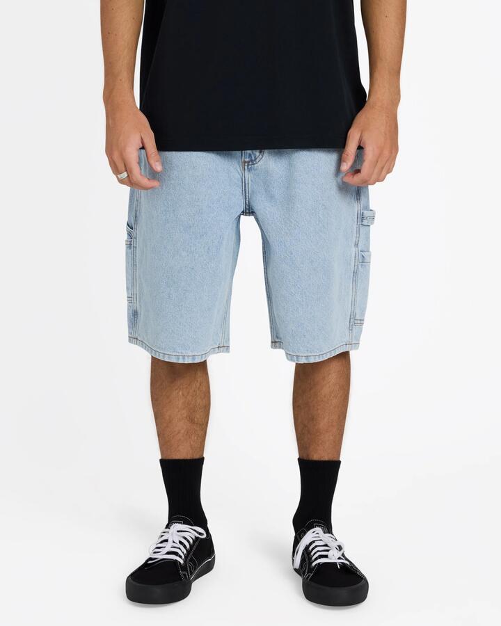 Image of a model wearing Shorts. Product name - Billabong Mens Bad Dog Workwear Denim Shorts Washed Indigo in Washed Indigo colour by brand - Billabong