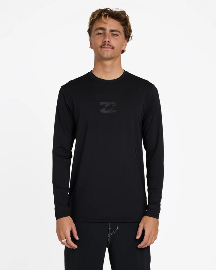 Image of a model wearing Tops. Product name - Billabong Mens All Day Wave Long Sleeve Rashguard Stealth in Stealth colour by brand - Billabong