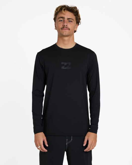 Image of a model wearing Tops. Product name - Billabong Mens All Day Wave Long Sleeve Rashguard Stealth in Stealth colour by brand - Billabong