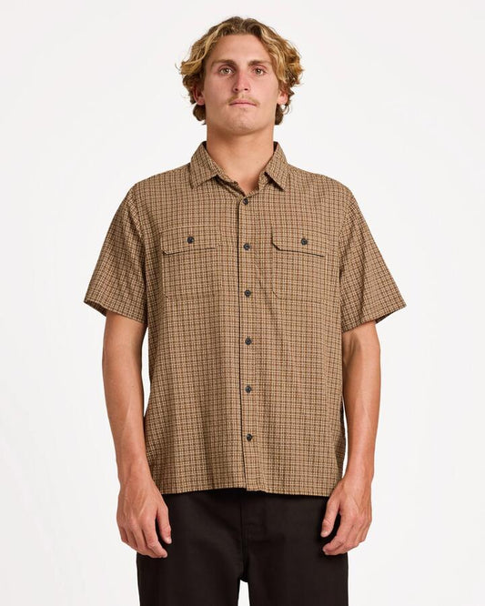 Image of a model wearing Tops. Product name - Volcom Mens Revel Short Sleeve T-Shirt Earth in Earth colour by brand - Volcom