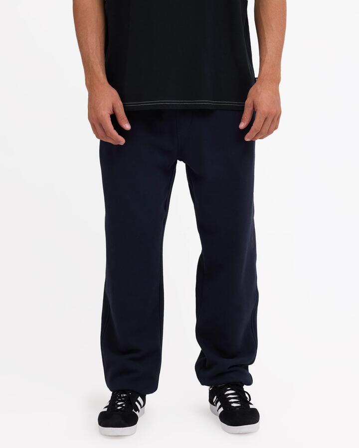 Image of a model wearing Pants. Product name - Quiksilver Mens Graphic Track Pants Dark Navy in Dark Navy colour by brand - Quiksilver