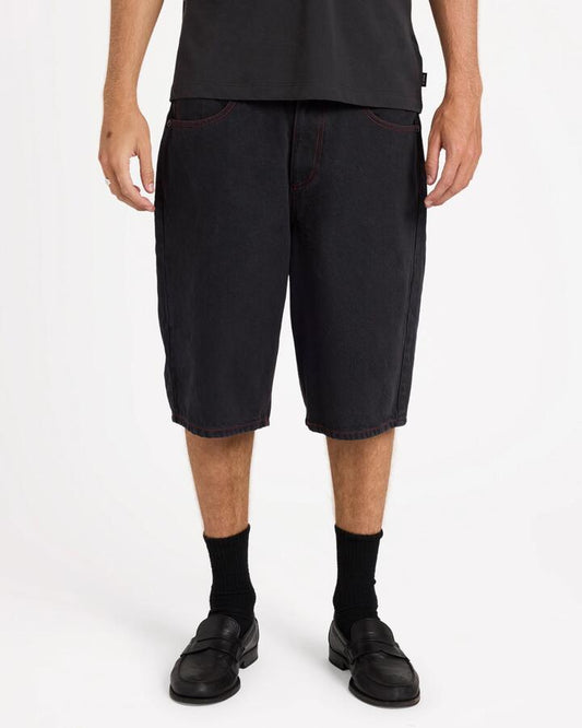 Image of a model wearing Shorts. Product name - Rvca Mens Dayshift Baggy Denim Shorts Black in Black colour by brand - Rvca