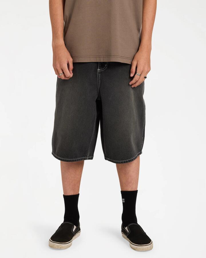 Image of a model wearing Shorts. Product name - Billabong Mens Spec Denim Shorts Black in Black colour by brand - Billabong