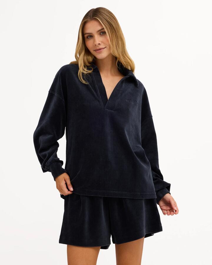 Image of a model wearing Tops. Product name - Billabong Womens Good Day 2 Polo Long Sleeve Shirt True Navy in True Navy colour by brand - Billabong