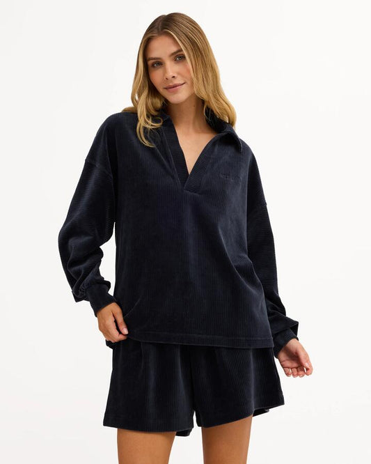 Image of a model wearing Tops. Product name - Billabong Womens Good Day 2 Polo Long Sleeve Shirt True Navy in True Navy colour by brand - Billabong