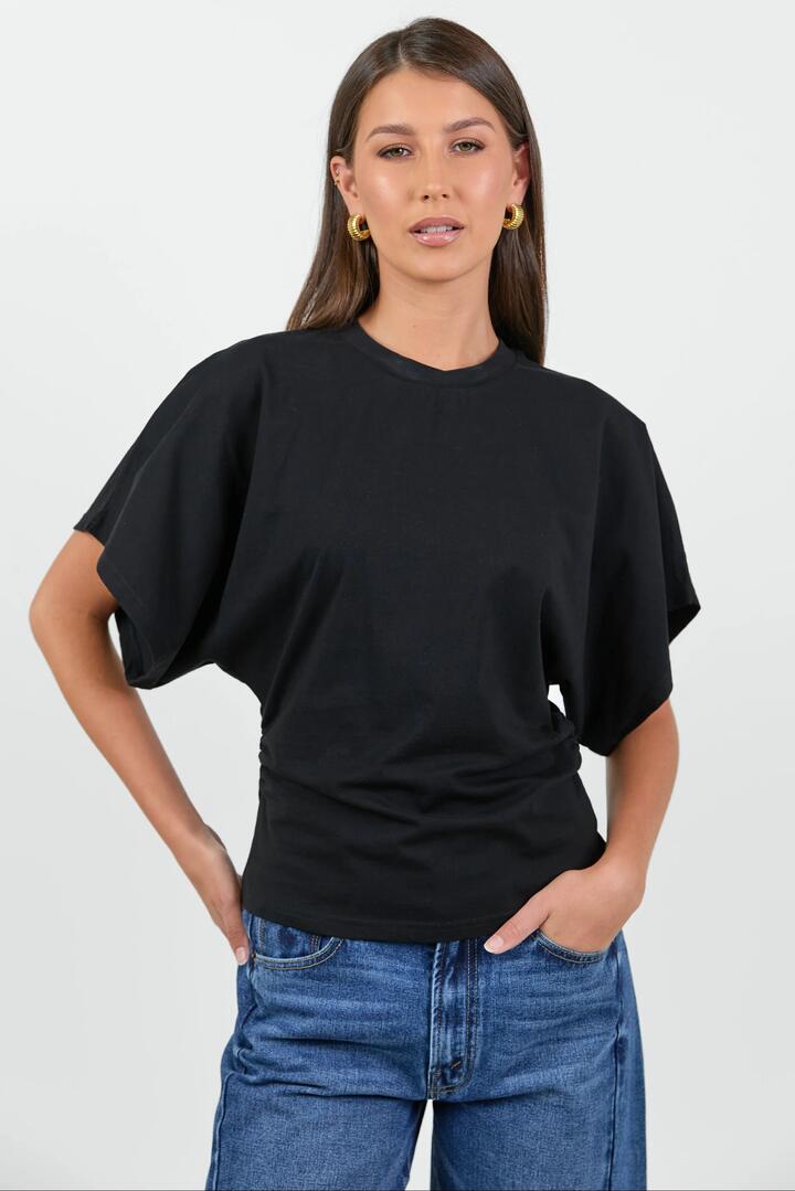 Image of a model wearing Tops. Product name - Cadence Black Cotton Gathered Waist Detail Short Sleeve Tee in Black colour by brand - RE:UNION Label